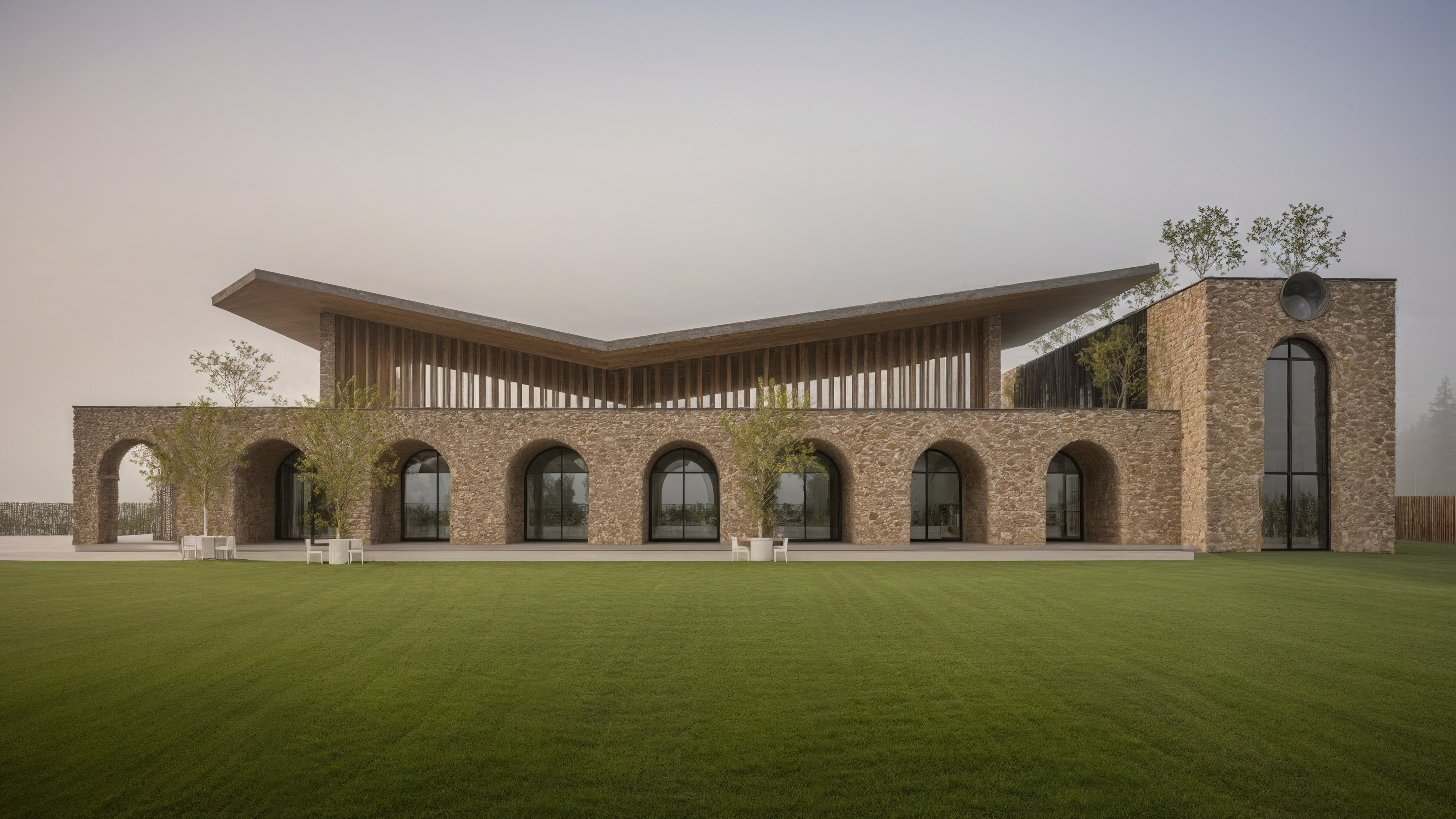 Stone architectural structure with arches and green lawn
